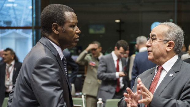African Union Commissioner for Peace and Security Ramtane Lamamra, right, talks with United Nations High Representative for Mali Pierre Buyoya during a ministerial meeting in 2013.