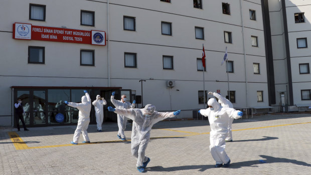 Turkish health officials perform an impromptu dance to celebrate the end of quarantine for health workers returning  from Kazakhstan and Russia.