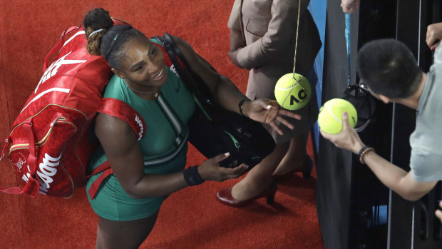 Williams signs autographs after defeating Simona Halep.