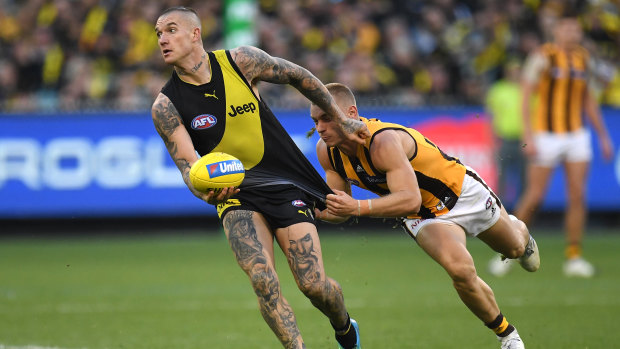 Thirst for ball: Dustin Martin (left) evades James Worpel.