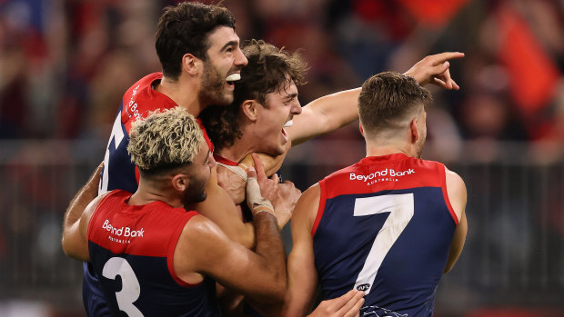 Christian Petracca, Christian Salem, and Jack Viney swarm young Demons ruckman Luke Jackson after a grand final goal.