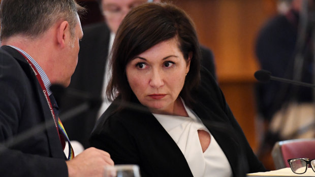 Queensland Minister for Environment, Great Barrier Reef, Science and the Arts, Leeanne Enoch (right) listens to advice from Jamie Merrick, the Director-General of the Department of Environment and Science, during a budget estimates committee hearing at Parliament House in Brisbane.
