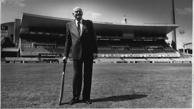 Bill O'Reilly stands in front of the stand at the S.C.G. which was renamed in his honour today. This was the first time out in the middle of the ground since his retirement from cricket in 1946.
