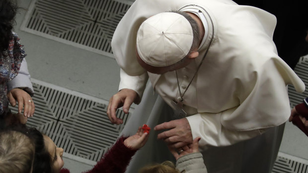 Pope Francis greets pilgrims at the end of his weekly general audience in the Paul VI Hall at the Vatican on Wednesday.