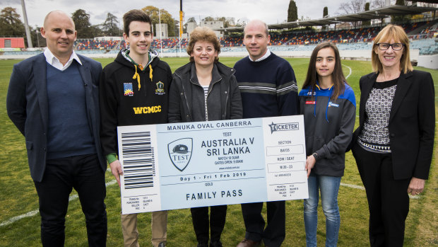 Cricket ACT boss Cameron French, left, and ACT venues director Liz Clarke, right, gave Canberra family Owen, Jenny, Chris and Clare Levings a family pass for the historic Test.
