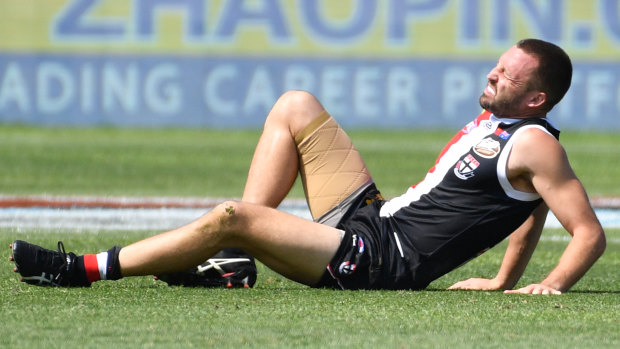 Down and out: St Kilda's Jarryn Geary suffers a serious blow during the match in Shanghai.