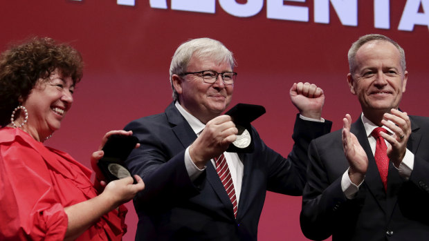 Opposition Leader Bill Shorten presents Therese Rein and former prime minister Kevin Rudd with lifetime membership at the Australian Labor Party national conference in Adelaide on Wednesday.