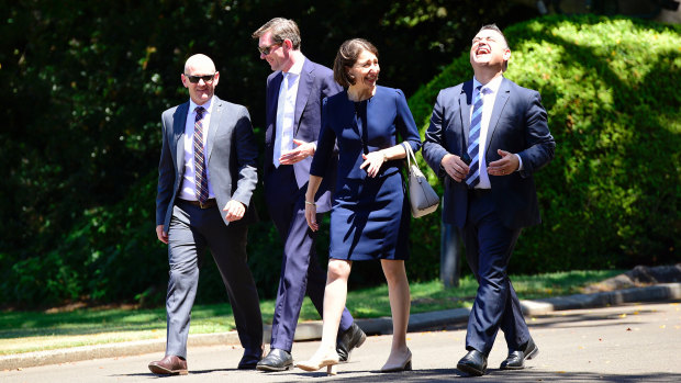 Former premier Gladys Berejiklian at Government House in 2017, with her cabinet colleagues, including then treasurer Dominic Perrottet (second from left) and the shoes that Michael Egan said weren’t “up to scratch”.
