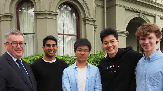 Camberwell Grammar students James Gunasegaram, Ian Chen, Andrew Zeng, and Lachlan Doig each achieved an ATAR of 99.95. They're with headmaster Paul Hicks. 