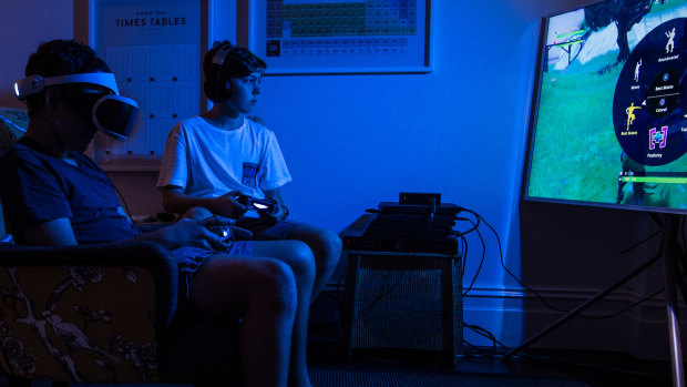  Billy Graham, 13, and his friend Benjamin Baskin playing an online game.