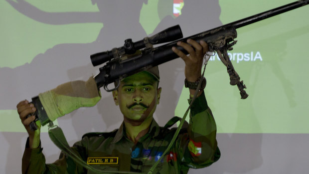 An Indian army officer displays a sniper gun recovered during a search operation along the Amarnath route, during a joint press conference in Srinagar, Indian-controlled Kashmir.
