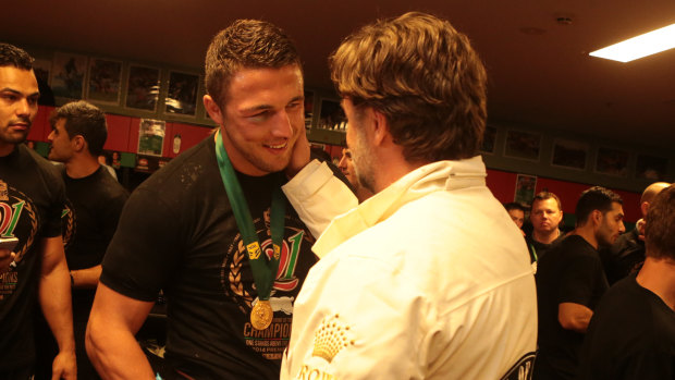 Sam Burgess talking with Russell Crowe after the Rabbitohs defeated the Bulldogs in the 2014 NRL grand final.