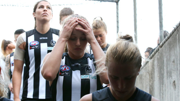 Collingwood players leave the field after their loss to Melbourne at Victoria Park.
