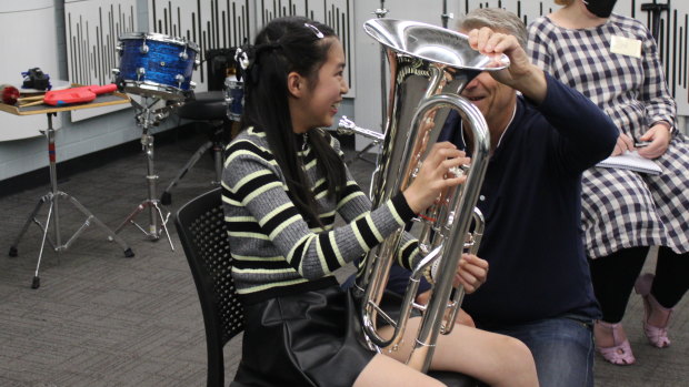 Tiana Ekpanyaskun trying out different instruments during the Adaptive Music Bridging Program.