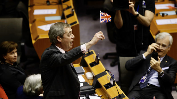 Nigel Farage, Member of the European Parliament and leader of the Brexit Party, waves a Union Jack flag ahead of a vote on the Brexit withdrawal agreement in Brussels on Wednesday.