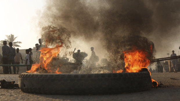 Pakistani protesters burn tyres while blocking a main road during a protest after a court decision to acquit the Christian of blasphemy charges.
