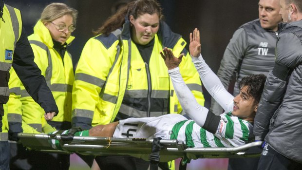 Daniel Arzani signals to the crowd following his knee injury on his Celtic debut.
