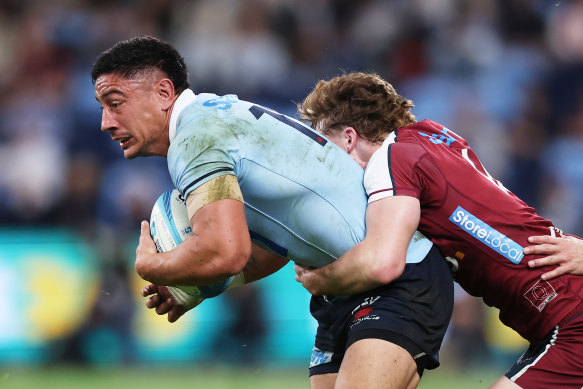 Lalakai Foketi of the Waratahs is tackled