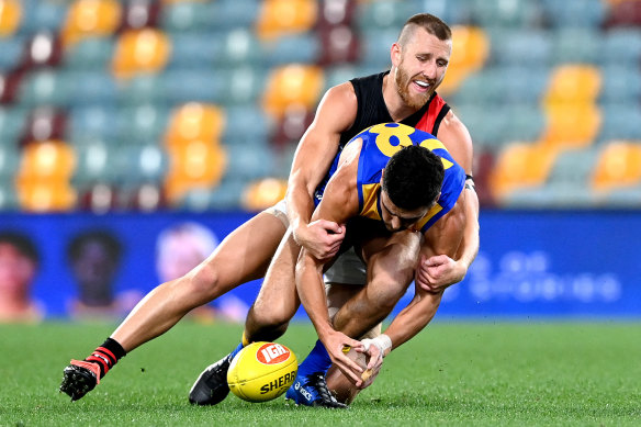 Dyson Heppell tackles West Coast’s Tom Cole in one of just three matches the Essendon captain played in 2020. 