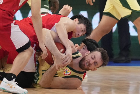 Japan guard Makoto Hiejima (6) and Australia forward Nick Kay (15) fight for a loose ball in the first half.