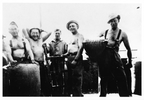 Members of the 6th Employment Company loading sacks in 1943. Saul Factor is second from the left.