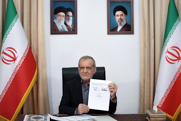 Iranian President Masoud Pezeshkian with the memorandum of understanding signed with US in June. 