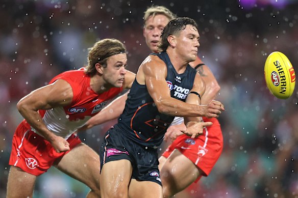 Harry Rowston dishes off a handball.
