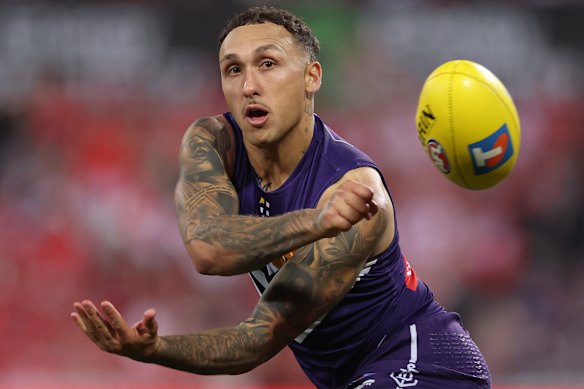 Fremantle’s Shai Bolton handballs the footy.