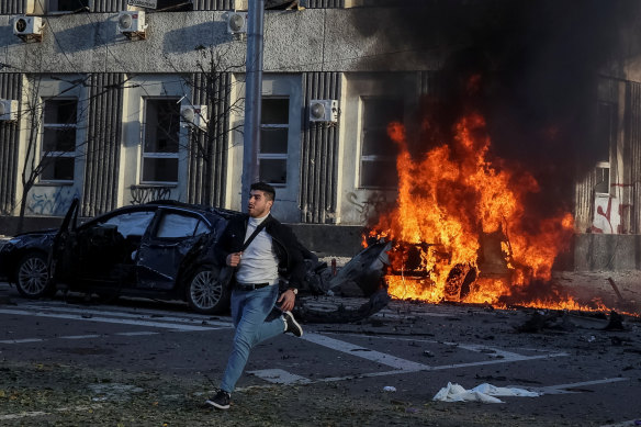 Cars burn after Russia’s military strike on the Ukranian capital.