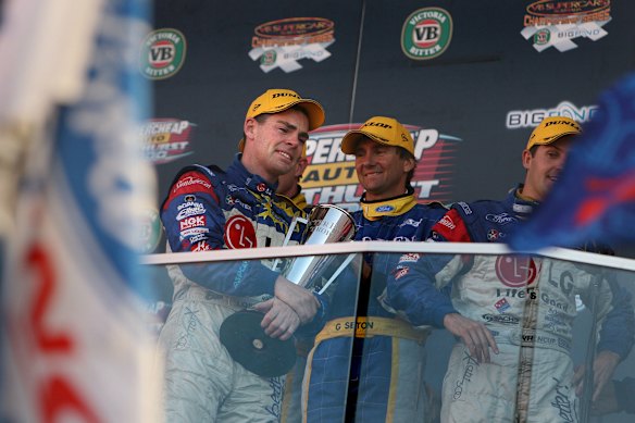 Craig Lowndes (left) hugs the Peter Brock Trophy as he weeps moments after winning the Bathurst 1000 in 2006.