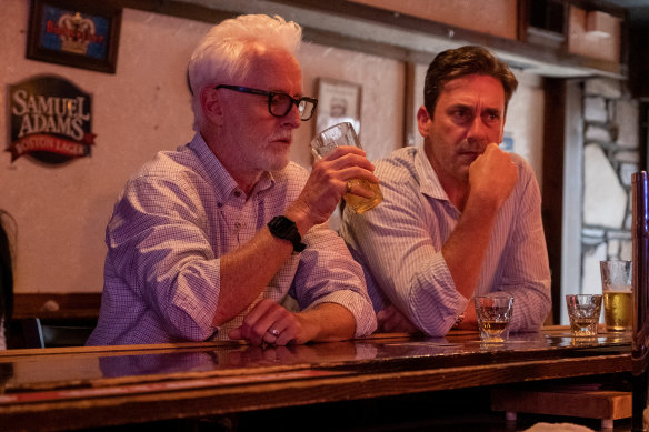 Jon Hamm (right, with John Slattery) as unconventional journalist Irwin Maurice ‘Fletch’ Fletcher in Confess, Fletch, a role once played by Chevy Chase.
