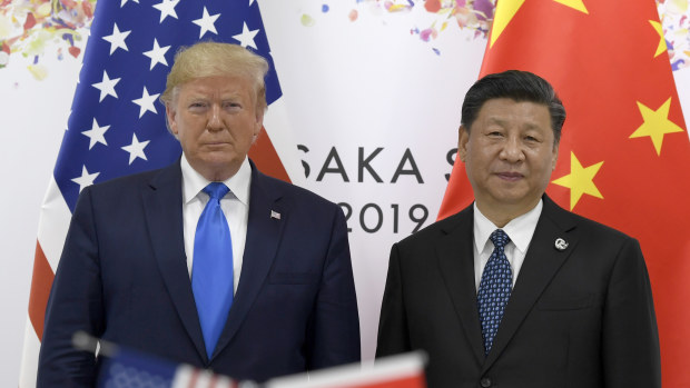 President Donald Trump, left, poses for a photo with Chinese President Xi Jinping during a meeting on the sidelines of the G-20 summit in Osaka, Japan.