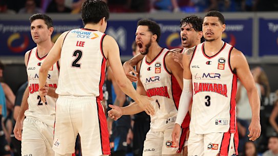 Tyler Harvey of the Hawks celebrates making a three pointer.
