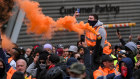 Protesters set off flares in the city on Tuesday in the second day of demonstrations.