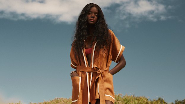 Duckie wears Oroton robe, $449, Wanderlust + Co bangle, $232, and Chuchka “Sunset” necklace and bracelet set, $89, all from The Iconic. All jewellery worn throughout. Bond-eye “Lissio” bikini top, $110. 