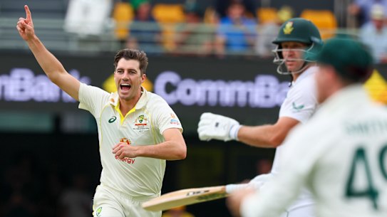 Pat Cummins celebrates one of his five second-innings scalps on the green Gabba pitch.