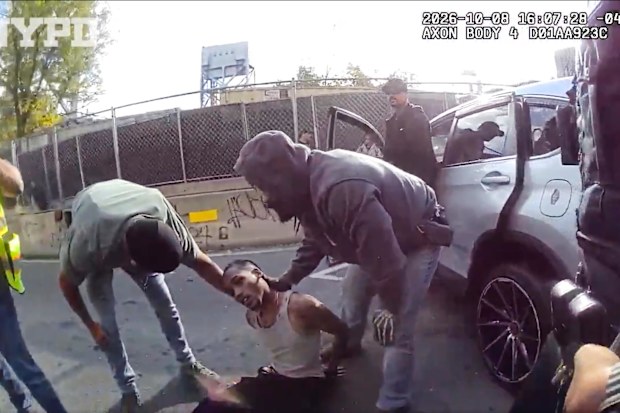 In this image taken from police-worn body camera video released the New York City Police Department (NYPD), law enforcement personnel tend to a Oscar Belgal, 28, a Dominican man who was shot by Federal immigration officers,, as he drove his car with a five-year-old boy inside.