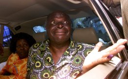 Mwai Kibaki, opposition leader of the National Rainbow Coalition, shows the dye on his finger after he cast his vote while sitting inside his car at a polling station in 2002.