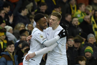 City’s Raheem Sterling and Liam Delap celebrate a goal.