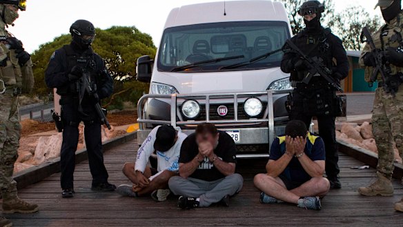 Police with some of those arrested back in December.
