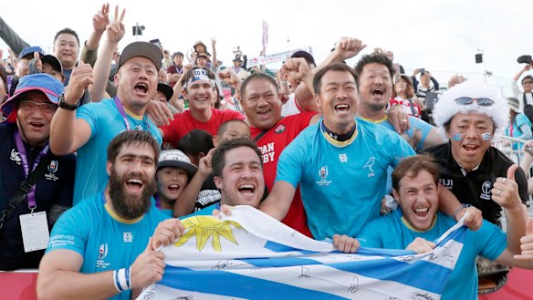 Triumphant Uruguayan players celebrate with the crowd after their stunning defeat of Fiji.