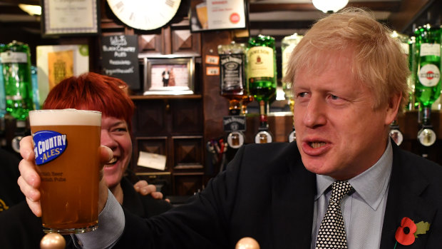 Something to cheer about: British Prime Minister Boris Johnson raises a pint of beer on the campaign trail. 