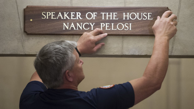 The sign at the office suite of House Speaker Nancy Pelosi is installed on Capitol Hill in Washington. 