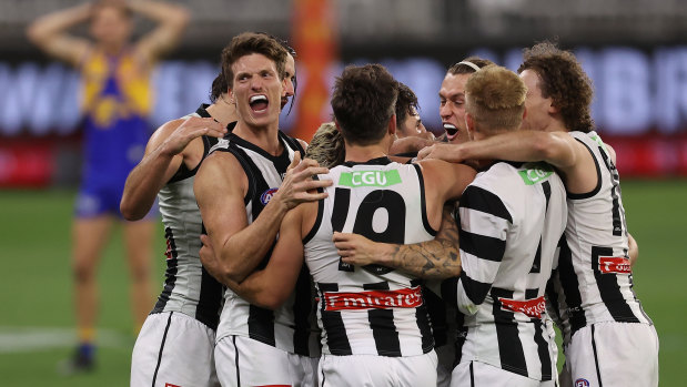 Collingwood players celebrate their win against West Coast.