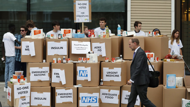Anti Brexit activists protest as they deliver a pile of medical supplies in cardboard boxes to the Department of Health and Social Care in London. They want to get a message to the public about the predicted costs of Britain's "No Deal Hard Brexit".