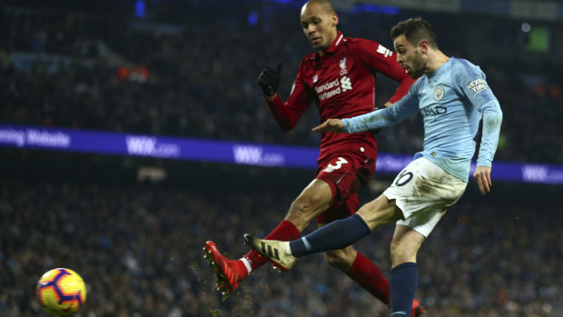 Classic duel: Manchester City’s Bernardo Silva shoots for goal in Friday’s match against Liverpool.