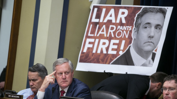 A poster on display during Michael Cohen's testimony to Congress.