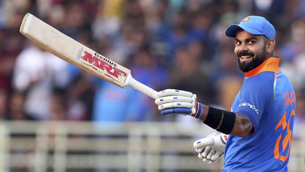 Virat Kohli celebrates scoring 10,000 ODI runs.