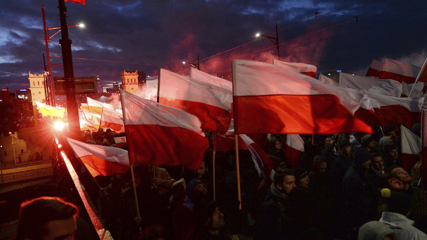 Demonstrators burn flares and wave Polish flags during the annual march in 2017.