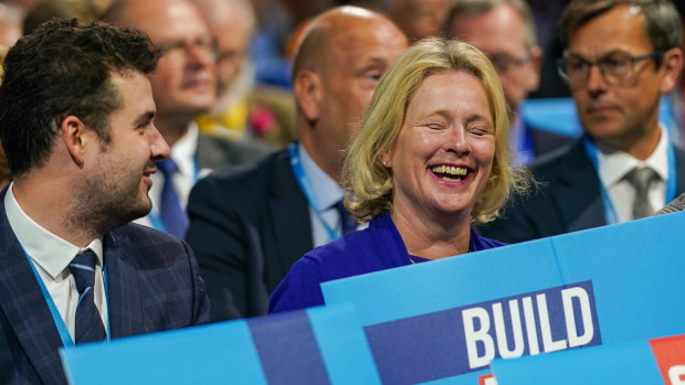 Delegates react as they wait to listen to Prime Minister Boris Johnson’s keynote speech during the Conservative Party conference in Manchester.